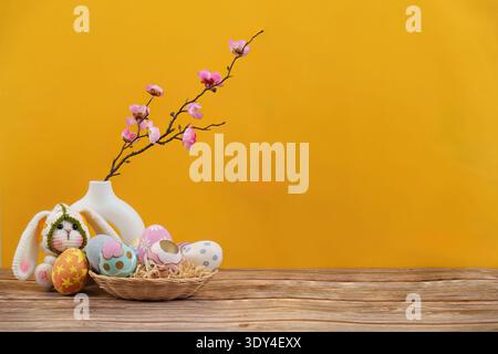 Easter Joy. Bunny and decorated eggs with spring flowers in a vibrant setting. Stock Photo