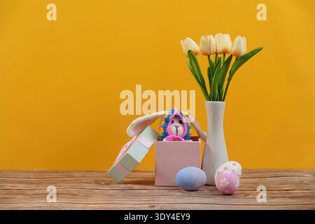 Easter Bunny Surprise. Cute bunny and colorful eggs in a festive spring setting. Stock Photo