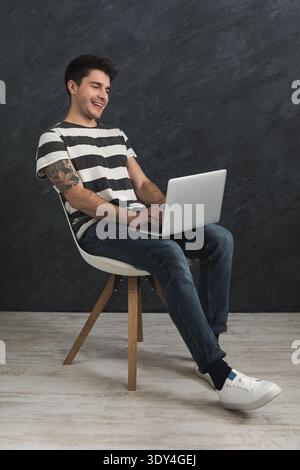 Handsome man using laptop in studio Stock Photo