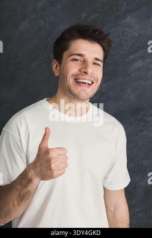 Young smiling man with thumb up portrait Stock Photo