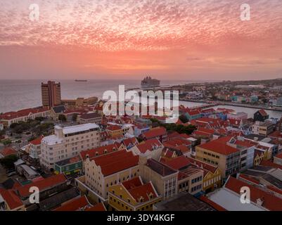 Aerial view of dramatic sunset sky over Willemstad Curacao with orange, red colors Stock Photo