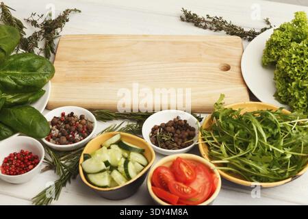 Various organic vegetables and spices on white kitchen table Stock Photo