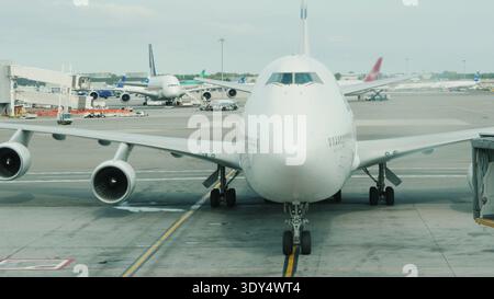 The arrival of a giant two-story airliner to the terminal. Slowly approaching the hub Stock Photo