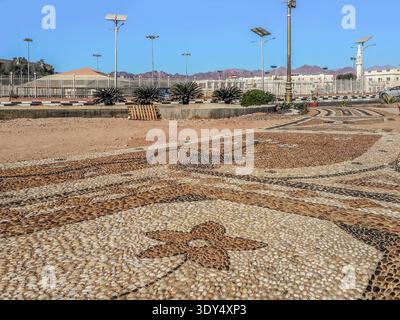 Decorative pattern on the town square paved with small beach pebbles in Sharm El Sheikh, Egypt. Creative pavement in Egyptian tourist city Stock Photo