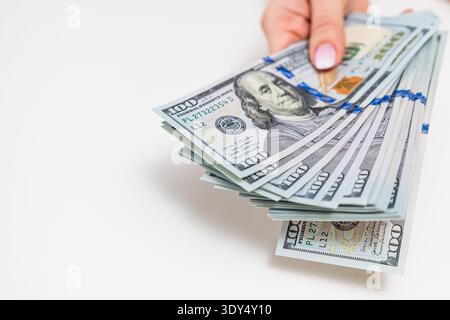 Woman carefully counting US dollar bills. Savings, accounting and household finance concept. Stock Photo