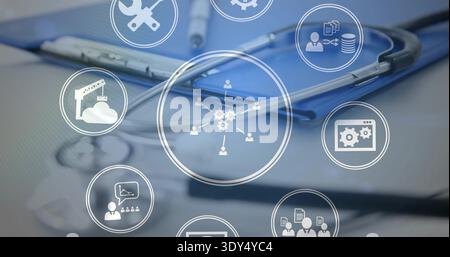 Resting metallic stethoscope coiled on blue clipboard at clinical desk, showing pen and UI icons Stock Photo