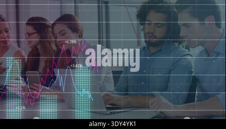 Collaborating five colleagues wearing biz casual analyzing charts in office on laptop and phone Stock Photo