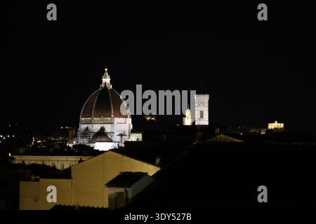 Illuminated Florence skyline with cathedral dome and historic towers Stock Photo