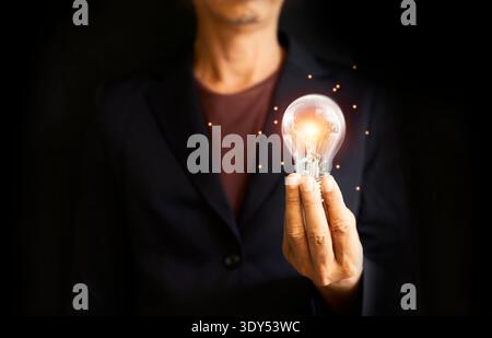 Hands holding light bulb for Concept new idea concept with innovation and inspiration, innovative technology in science and communication concept Stock Photo