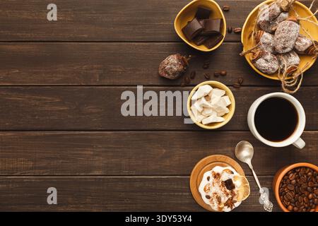 Coffee cup and sweets on vintage wooden table, top view Stock Photo