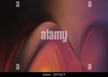 Abstract blurred background featuring shades of pink orange and black creating a soft gradient effect Stock Photo
