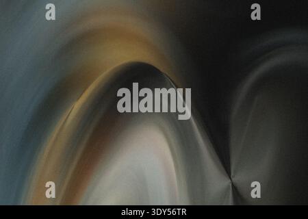 A blurry abstract image featuring shades of yellow and dark tones creating an indistinct composition Stock Photo