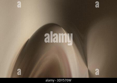 A blurry close up of a guinea pig with white and brown fur near a light colored wall in soft focus Stock Photo