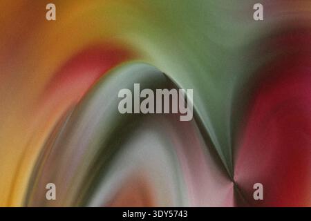 Abstract blurred image featuring a blend of green red and yellow colors creating a swirling effect design Stock Photo