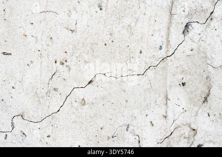 Grunge weathered shabby concrete surface wall with crack macro Stock Photo