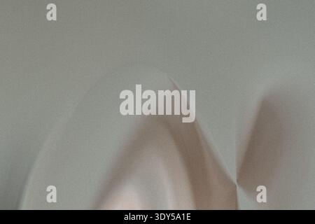 A blurry close up shot featuring two hands against a light background with soft diffused lighting effects Stock Photo
