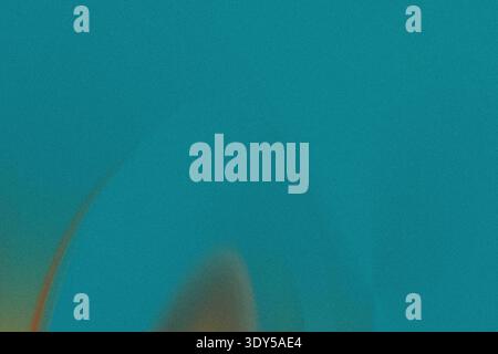 A blurry teal background with hints of green and brown creating an abstract and calming visual effect Stock Photo