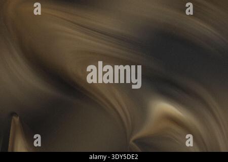 A blurry close up shot featuring indistinct shapes and muted colors creating an abstract composition Stock Photo