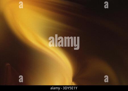 A close up view of bright orange and yellow flames flickering against a dark background creating warmth Stock Photo