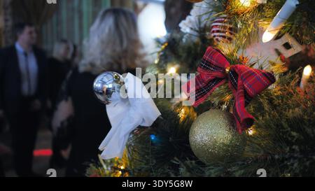 Christmas tree decorating for holiday celebration with festive baubles and bows Stock Photo
