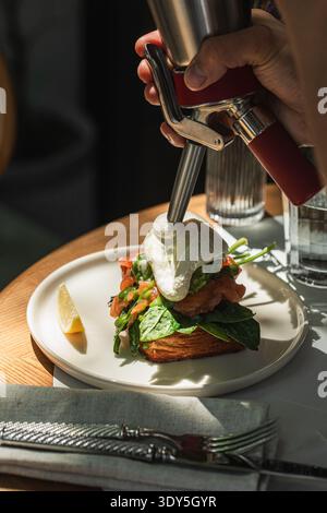 Salmon toast with poached egg and spinach Stock Photo