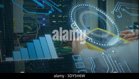 Monitoring tech's hands with light cuff holding tablet, viewing HUD in server room with racks, LEDs Stock Photo