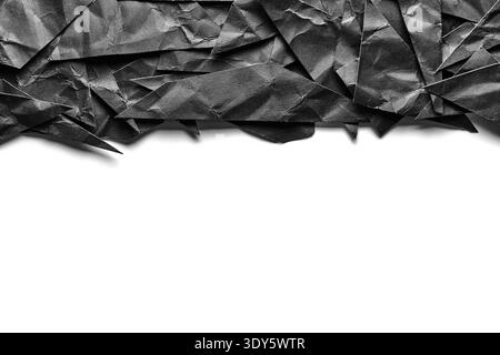 Creative banner design featuring dark, crumpled geometric paper triangles layered along top edge against clean, white background Stock Photo