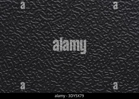 Macro texture of black matte plastic with embossed pattern. Industrial background, surface of equipment housing Stock Photo