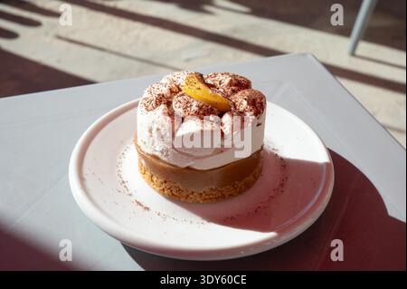 Banoffee pie dessert served on a plate in warm sunlight, highlighting creamy texture and caramel tones in a relaxed Mediterranean setting Birzebbuga, Malta, 6 DEC 2025. Stock Photo