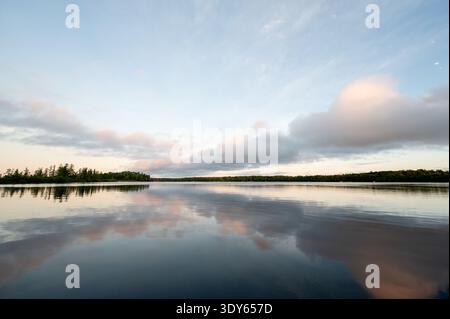 Peaceful warm summer sunrise over Pioneer Lake in Conover, Wisconsin Stock Photo