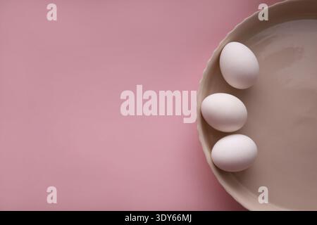 composition of three eggs on round ceramic plate Stock Photo