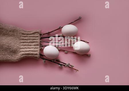 Willow catkins and eggs arranged inside a knitted sweater sleeve Stock Photo