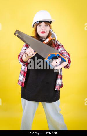 Young woman holding construction tools ready for work Stock Photo