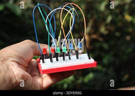 Breadboard circuit with jumper cables and different colored LED connected to each other for some electronic project prototyping Stock Photo