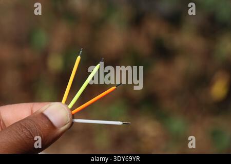 LED filament lamp parts of various color held in the hand. Lamp spare parts Stock Photo