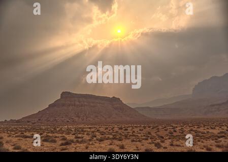 Sunlight shines through smoke from the Dragon Bravo Wildfire near Vermilion Cliffs National Monument in Arizona at sunset Stock Photo