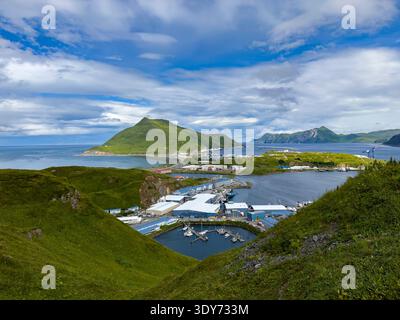 Clear view from Bunker Hill overlooking commercial harbor and mountains in Unalaska, Alaska on a sunny day Stock Photo