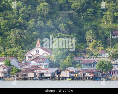 View of village buildings and church in Kokas, a Muslim-majority area on Papua island, Indonesia, showcasing local architecture and community life Stock Photo