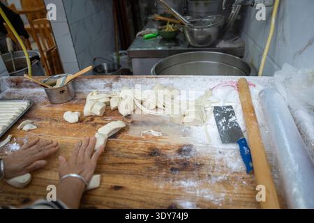 Handmade noodles on wooden cutting board in kitchen found in Sichuan, China Stock Photo