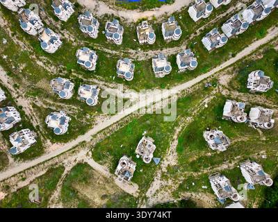 Abandoned town of fairy tale castles shown from above in Turkey with winding paths and overgrown areas Stock Photo