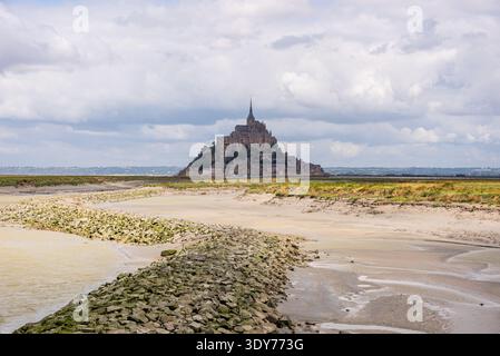 Mont Saint-Michel across sandy tidal channels at low tide in Normandy France Stock Photo