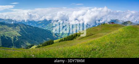 View from Schmittenhohebahn top station overlooking mountains and clouds on a sunny day in Austria Stock Photo