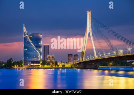 Riga, Latvia. Vansu Bridge over Daugava River, twilight illuminated view. Stock Photo