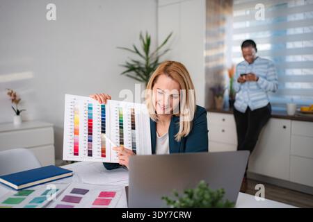 Woman presenting color swatches during online design meeting Stock Photo