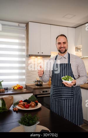 Man chef showing organic Brussels sprouts giving thumbs up Stock Photo