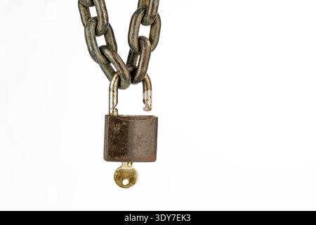 A rusty chain padlock key security concept, old metal lock isolated, broken shackle, antique protection symbol on white background tension contrast mi Stock Photo