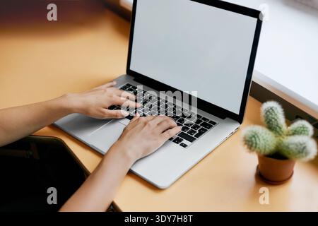Young women working on her laptop with blank copy space screen for your advertising text message in office, Back view of business woman hands busy usi Stock Photo