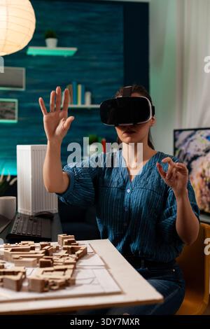 Construction architect using modern vr glasses device for development concept vision on business layout digital hologram. Professional woman working with visual software technology Stock Photo