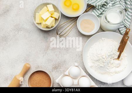 Assorted fresh ingredients for baking dough on a light kitchen counter background Stock Photo