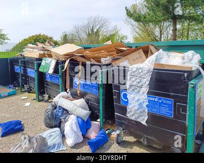 Waste Recycling Bins Filled With Cardboard And Household Trash Items. London, UK, 13 April 2024 Stock Photo